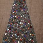 A hessian sack decorated with old jewellery, in the shape of a Christmas Tree, recyled artwork by Anne Bickley
