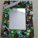 Mirror with frame made from recycled items by Anne Bickley
