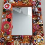 Mirror with frame made from recycled items, pretty pinks by Anne Bickley